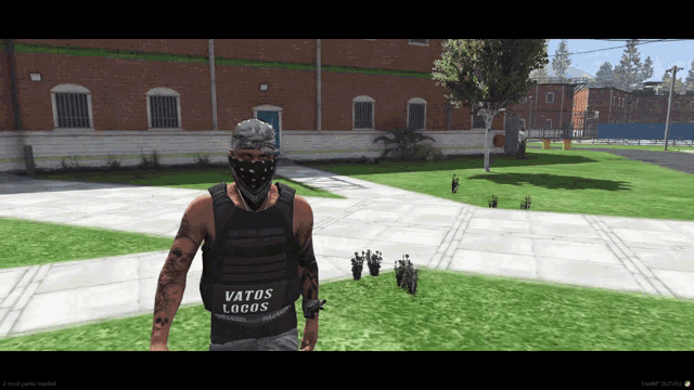 a man wearing a vest that says " vatos locos "