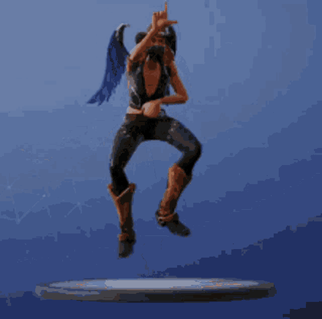 a figurine of a woman in a cowboy hat is dancing on a platform .