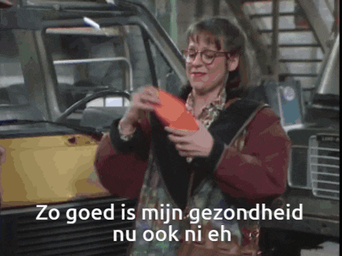 a woman with glasses is holding a red envelope and says zo goed is mijn gezondheid