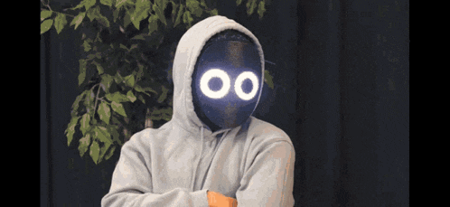 a man wearing a hoodie with a mask on his face that says 00