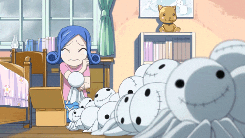 a girl in a pink shirt is standing in front of a pile of stuffed animals