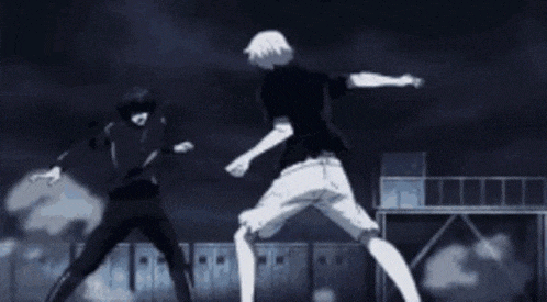 a man is kicking another man in the face while they are doing a handstand in a dark room .