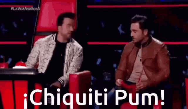 two men are sitting next to each other on a stage with the words chiquiti pum written on the bottom