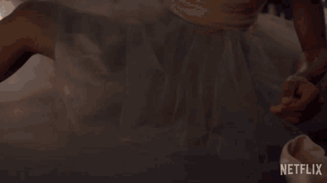 a woman is putting on a pair of pointe shoes with netflix written on the bottom