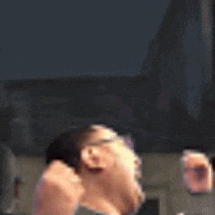a man with glasses is laughing with his mouth open and his tongue hanging out .