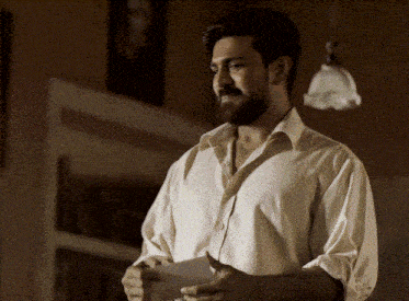 a man with a beard is wearing a white shirt
