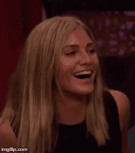 a woman is laughing with her mouth wide open in a crowd .