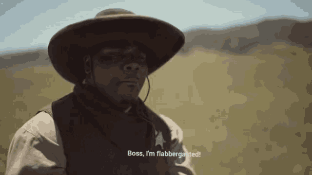 a man in a cowboy hat and vest says boss i 'm flabbergasted