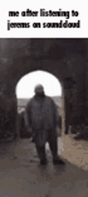 a man is standing in the middle of a tunnel while listening to a song on soundcloud .