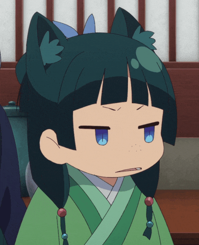a girl with black hair and blue eyes is wearing a green robe