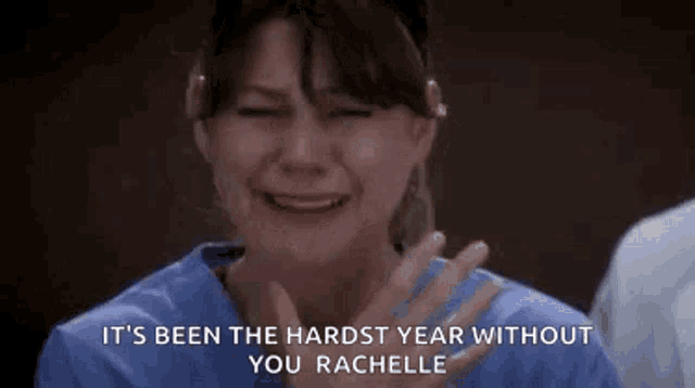 a woman in a scrub top is crying in a hospital room while a man applauds .