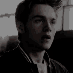 a close up of a young man 's face with his mouth open