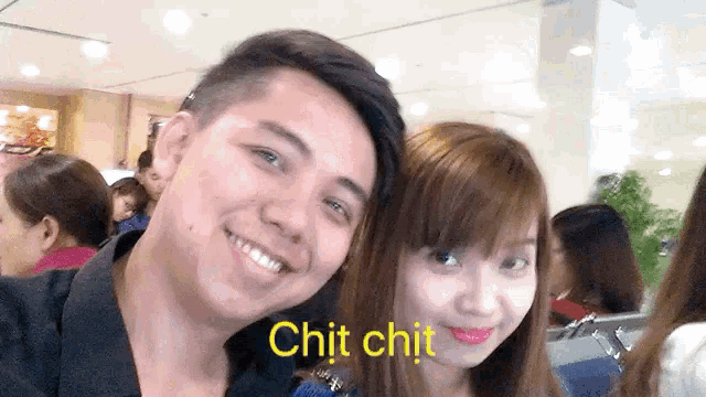 a man and a woman are posing for a picture with the words chit chit in yellow