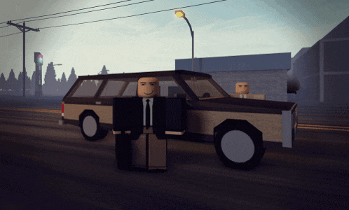 a man in a suit and tie stands next to a car