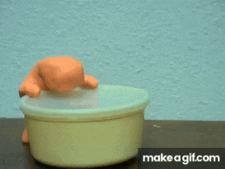 a gif of a toy turtle taking a bath with the words make a gif.com below it