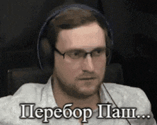 a man wearing headphones and glasses is sitting in front of a computer .