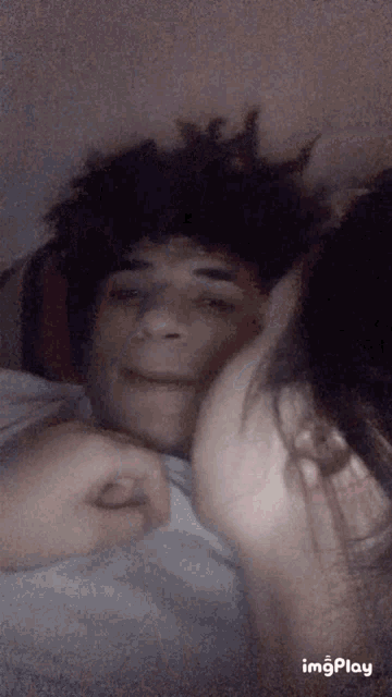 a woman is kissing a man on the cheek in a blurry photo that says imgplay at the bottom