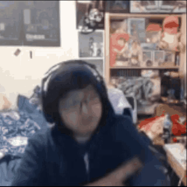 a blurry picture of a person wearing headphones and a hoodie