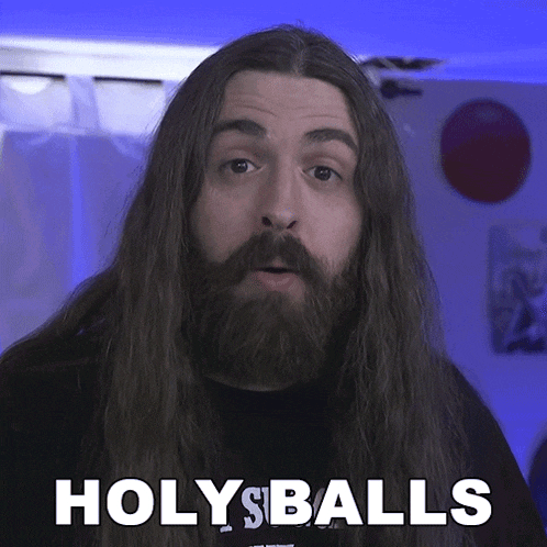 a man with long hair and a beard has the words holy balls above his head