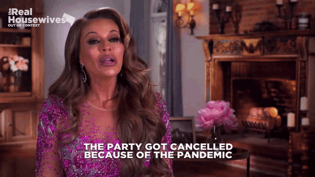 a woman says the party got cancelled because of the pandemic in front of a fireplace