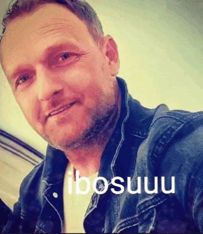 a man in a denim jacket is taking a selfie with the word ibosuu on the bottom