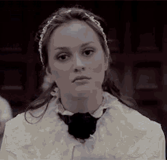 a woman wearing a headband and a white shirt