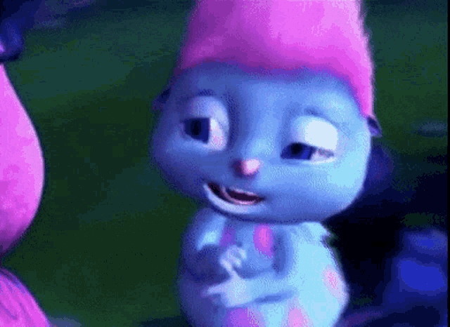 a blue cartoon caterpillar with a pink hat on is smiling .