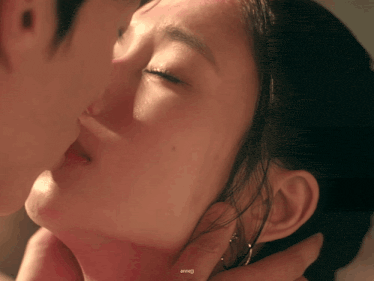 a close up of a man kissing a woman 's neck with a watermark that says annel
