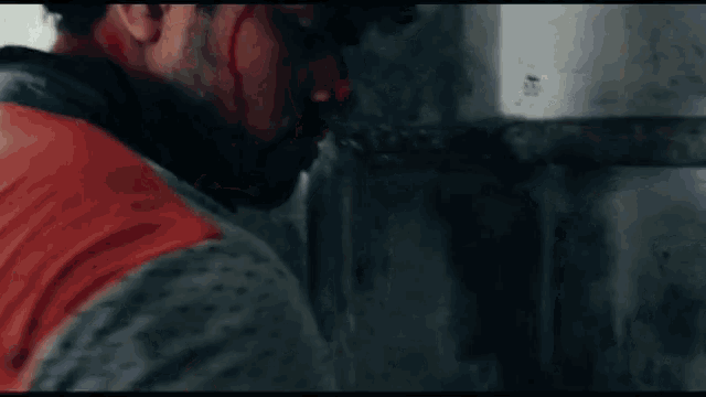 a man with blood coming out of his nose is looking down