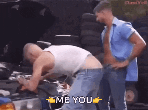 two men are working on a car and one of them is pointing at the other and saying me you .