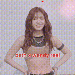 a picture of beth x wendy real with pink flowers behind her