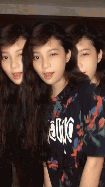 three girls are standing next to each other and one of them is wearing a t-shirt that says " exotic "