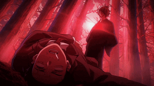 a man is laying on the ground in a dark forest with a red light behind him