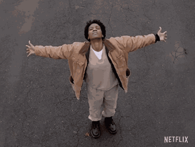 a man is standing with his arms outstretched in front of a netflix sign