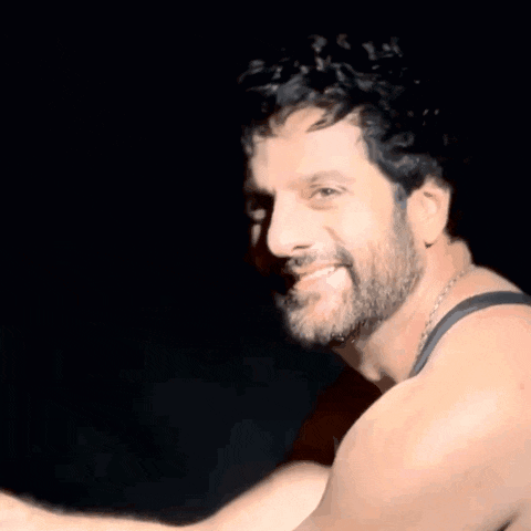 a man with a beard wearing a black tank top