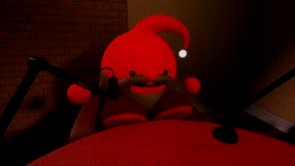 a stuffed toy is sitting in front of a microphone on a bed .