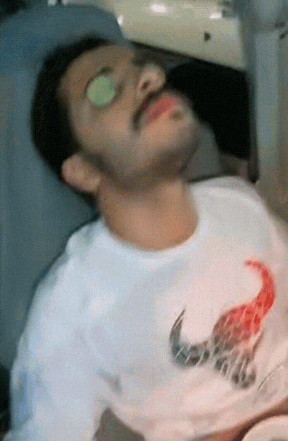 a man in a white shirt with a scorpion on it