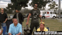 a group of people are gathered in a park with a hosted at gifsforum.com advertisement