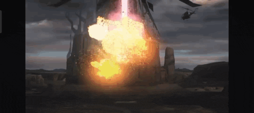 a large explosion is taking place in the middle of a desert with a helicopter flying in the background .