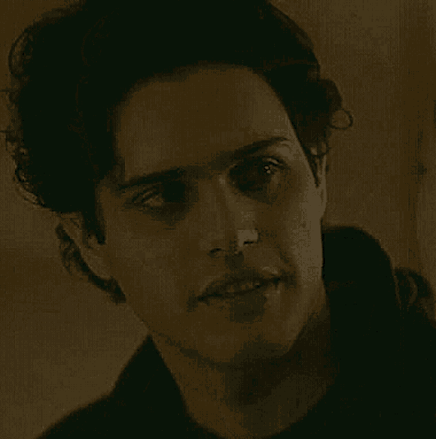 a close up of a man 's face in a dark room .