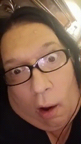 a woman wearing glasses and headphones makes a funny face