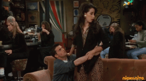 a man is holding a woman 's arm in a scene from a show called friends