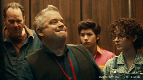 a group of people in an elevator with the words ghostbusters frozen empire