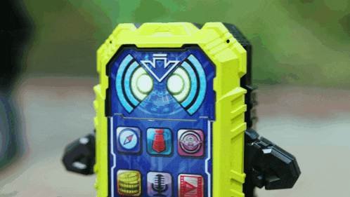 a yellow and blue toy cell phone with a compass and coins on the screen