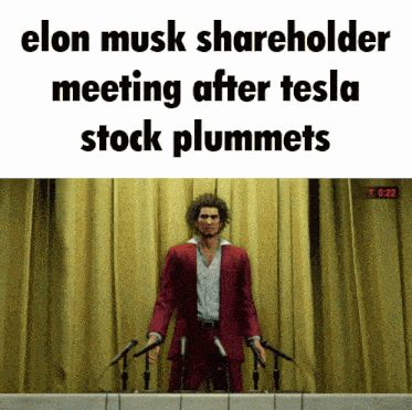 a man in a red suit stands in front of microphones with the words elon musk shareholder meeting after tesla stock plummets below him