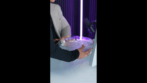 a man drinking from a bowl with the time 9:09 am on the bottom