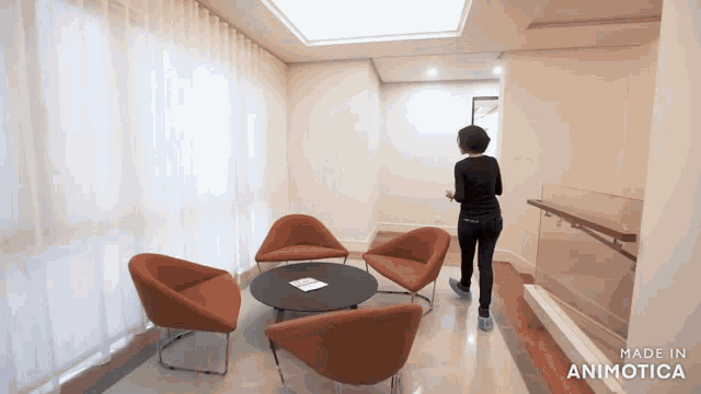 a woman is walking through a room with chairs and a table made in animotica