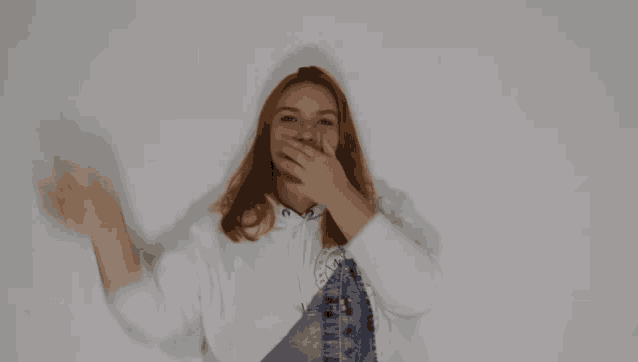 a blurry photo of a woman covering her face with her hands
