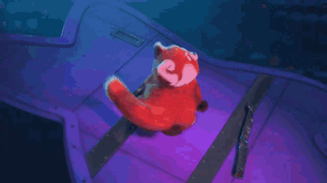a red panda is sitting on a purple surface with a blue background