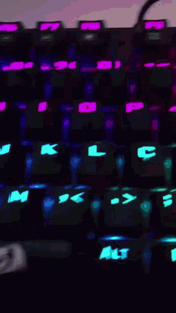 a close up of a keyboard with the letters k l and c glowing
